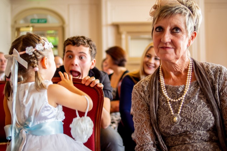 A guest pulls a face at the flower girl during a wedding at The Ship Hotel in Brighton, East Sussex.