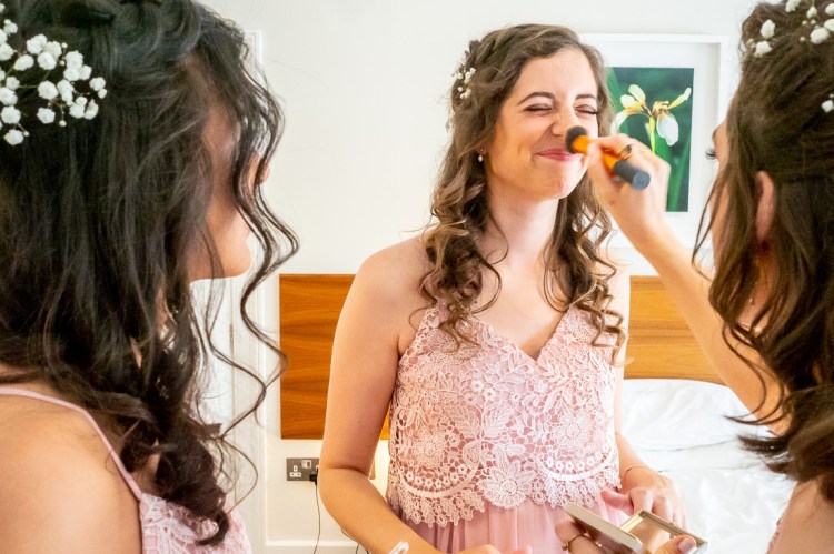 A bridesmaid has her nose powdered ahead of a wedding at Worcester College in Oxford.