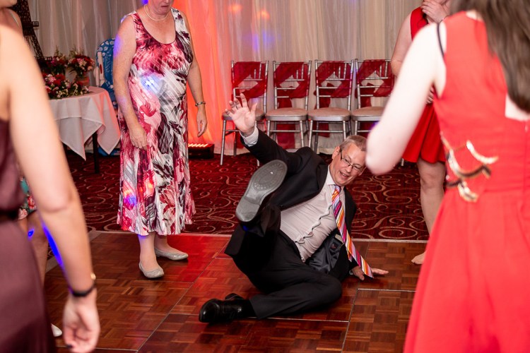 A male guest falls over on the dancefloor, during a wedding at Sedgebrook Hall in Northamptonshire.