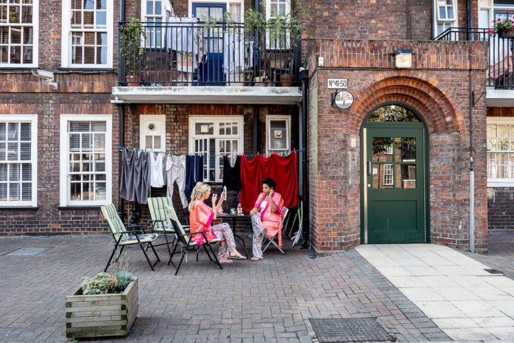 Bridesmaids getting ready outside on the morning of a wedding at Southwark Cathedral in London.