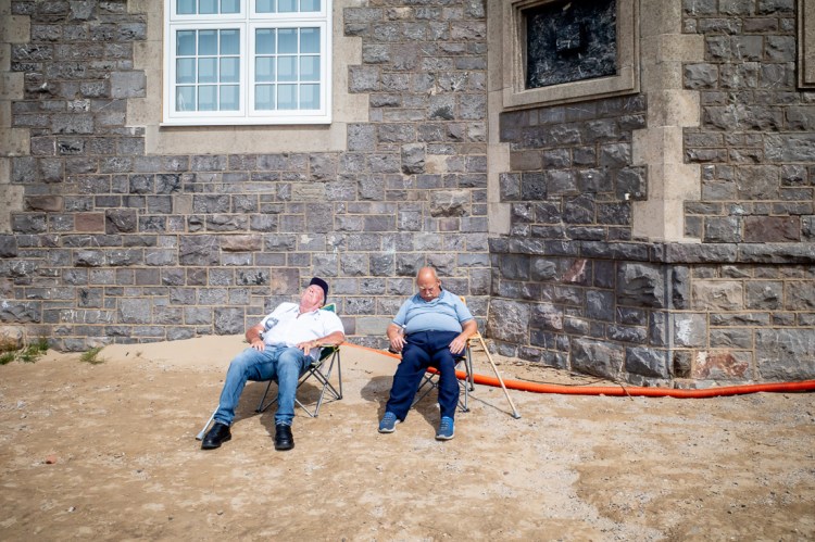 Candid street photography of  old men snoozing on the beach in Weston-super-Mare.